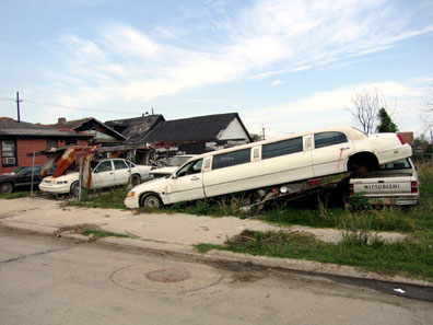 This stretch limo (!?!) was piled on top of a pickup truck and a motorcycle
